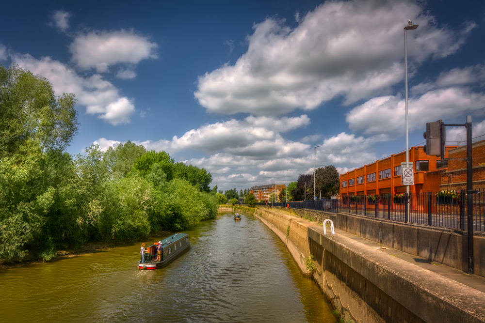 Narrowboats heading upriver from Gloucester Lock passing The Quay