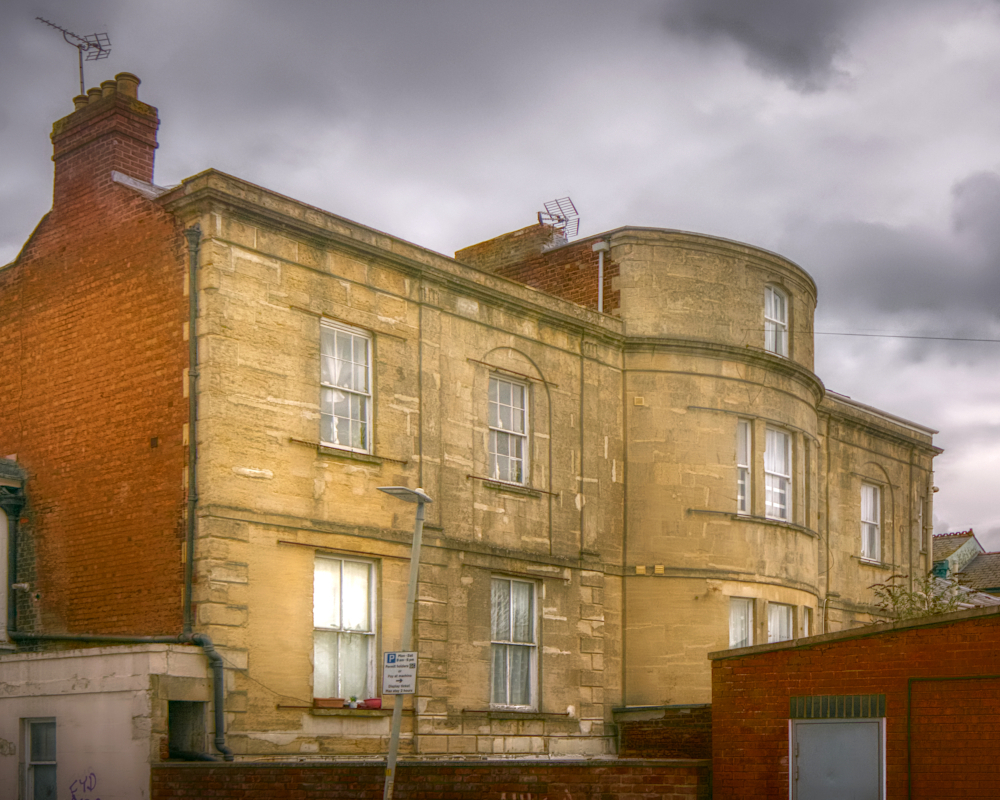 Rear view of Mynd House, built c.1800 for a barrister, later sub-divided into Nos. 96–100 Eastgate Street and its extensive gardens built over.