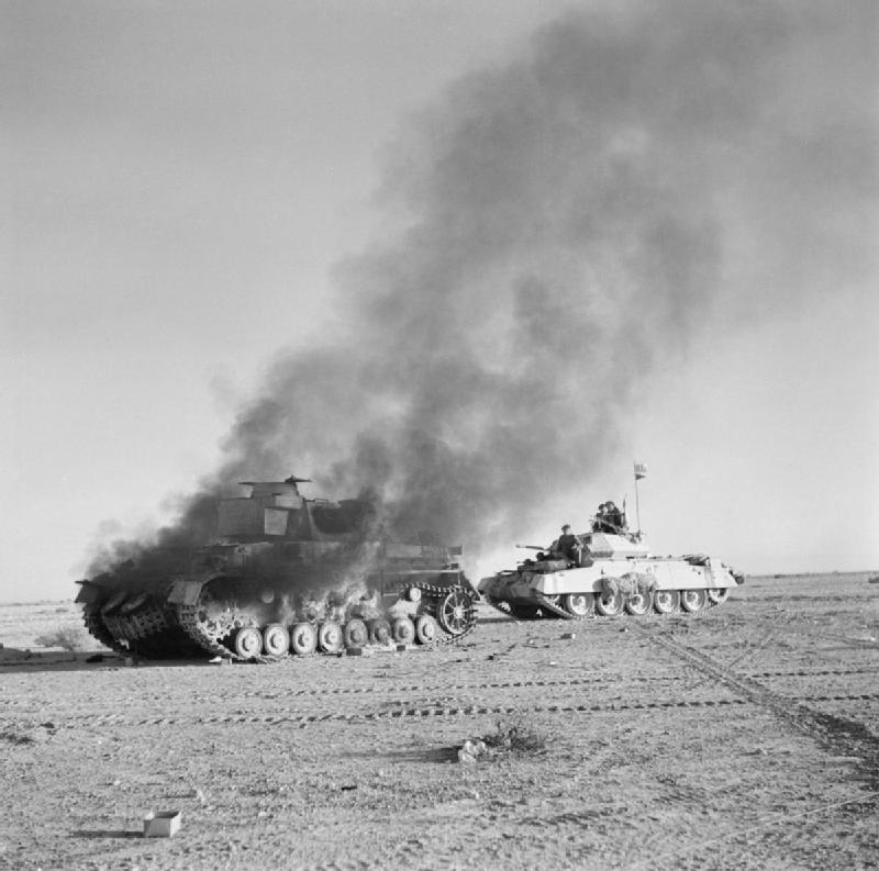 Royal Gloucestershire Hussars tank passing a burning German tank in North Africa