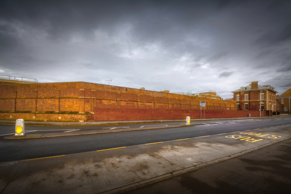 Prison wall and road where castle wall and moat once were