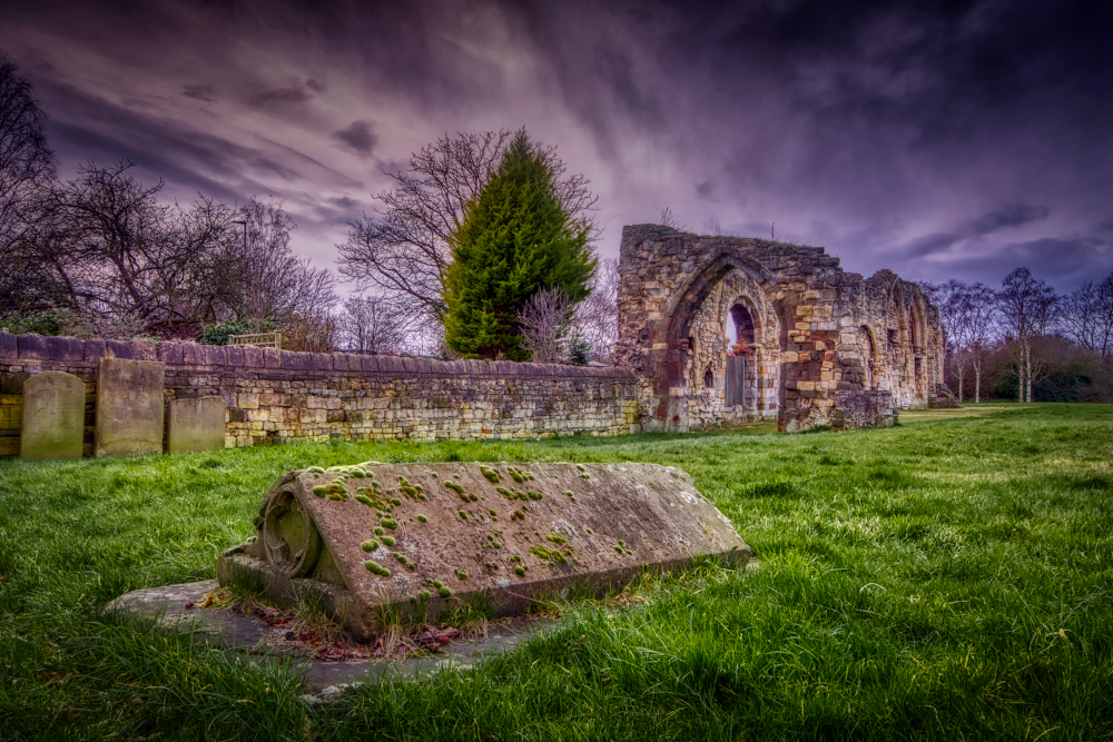 Ruins of St. Oswald's Priory originally built by the Saxons with recycled Roman stone